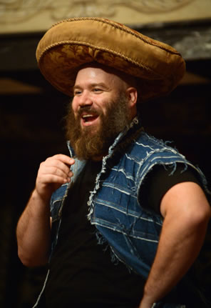 Falstaff, in ragged denim vest, with a seat cushion on his head