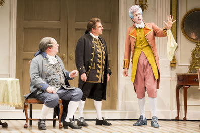 Dangle seated on chair in blue, Sneer standing next to him in brown, both looking at Puff describing something, handkerchief draping from the cuff of  his outstretched left arm